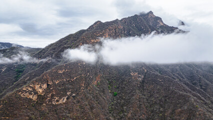 Panoramic aerial drone view of the mountains of Mayasc&oacute;n covered by clouds, Lambayeque, Peru