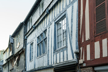 Naklejka premium Facade of an old wooden building with blue and brown beams in Normandy, France
