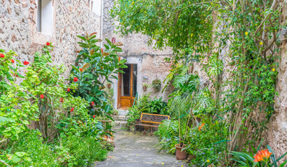 Beautiful street in Valldemossa with traditional flower decoration, famous old mediterranean...