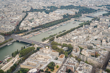 An aerial view of a part of the city of Paris, showing an Orthodox Christian church The church has golden domes, and the streets and the river are visible