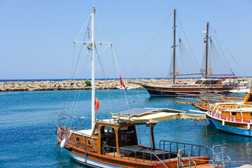 A group of boats are docked in a marina, with one of them being a sailboat in Turkey