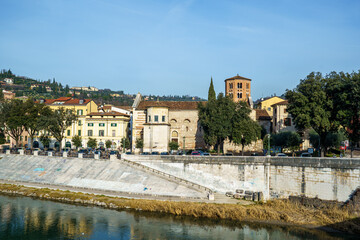 A stone embankment in Verona, Italy. Part of the city panorama is visible at the top