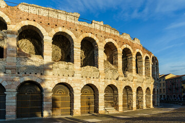 The building of the ancient Arena Colosseum theater in Verona, Italy The weather is good, the sky is blue, a few clouds are visible