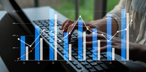A business professional reviews financial data, typing on a laptop keyboard, with charts and graphs overlaying the image, emphasizing analysis and growth trends in the workspace. Scalp