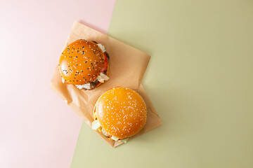 Description
Two burgers with visible fillings (lettuce, tomato, cheese, and meat patty) are placed...