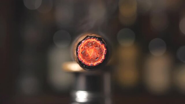 Macro slow motion shot of lighting a cigar tip with a blue torch flame revealing glowing embers