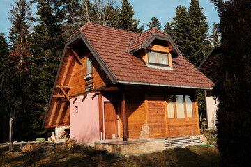 Modern wooden mountain house with terrace among forest trees in Tara National Park, Serbia. Comfortable housing integrated into nature.
