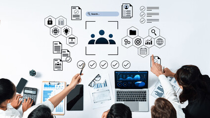 A modern office scene showcasing professionals collaborating on data analysis. The image features charts, digital technology, teamwork, and strategic planning elements. Gantry