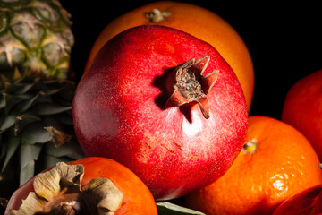 pomegranate fruit mix on black background
