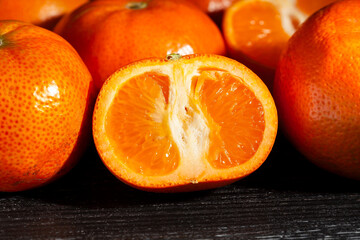 sliced tangerine on black background