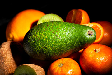 avocado tropical fruit mix on black background
