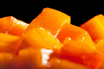 chopped persimmon on black background