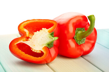sliced bell pepper on wood background on white