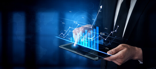 A business professional examines data on a digital tablet, showcasing dynamic financial graphs and market trends in a sophisticated office environment. Scalp