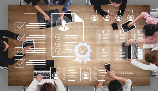 A diverse team collaborates in a modern workspace, reviewing important documents on laptops and tablets, ensuring effective communication and workflow efficiency. Gantry