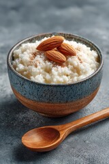 Traditional Finnish rice pudding with almonds and cinnamon in ceramic bowl, evoking Nordic comfort food and winter holiday atmosphere