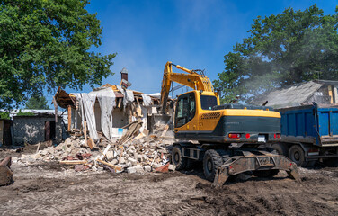 Excavator tearing down old house at demolition site. Urban redevelopment, debris removal, heavy machinery, construction cleanup and deconstruction process in action.