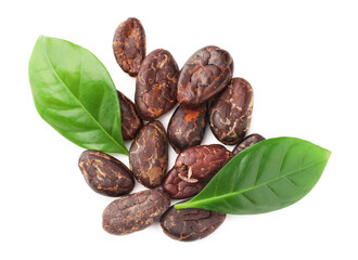 Obraz premium Natural cocoa beans and green leaves isolated on white, top view