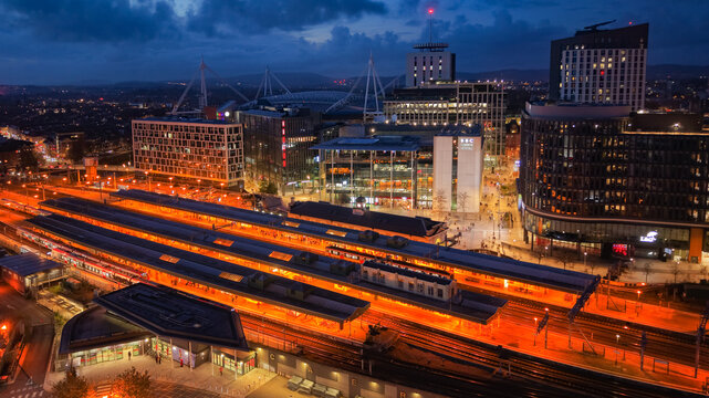 Aerial drone photo of Cardiff city centre at night, featuring Central Square, BBC studios, bus and railway stations.