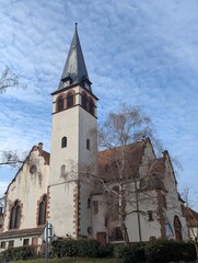 Historic Church Tower with Gothic Architecture and Picturesque Sky in European Town