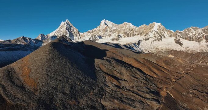 Aerial footage of beautiful snow capped mountain and lake sunrise landscape in Tibet, China