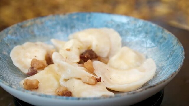 Dumplings blue plate Dumplings gyoza mandu on a blue plate with wooden chopsticks. High quality 4k footage