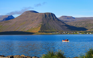 Beautiful bay with colorful buildings and steep mountains around. &Iacute;safj&ouml;r&eth;ur - 'Fjord of ices' is the heart of the Westfjords and the largest town on the Vestfir&eth;ir peninsula of northwest Iceland.