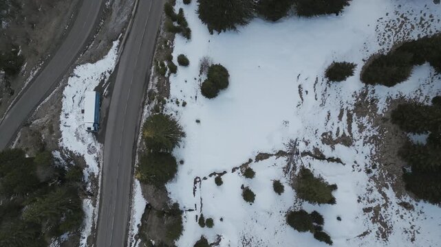 4K Bird&rsquo;s-Eye Drone Shot Descending and Rotating Over Snowy Mountain Road Near Flaine, French Alps
