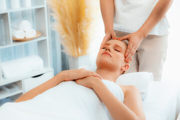 Caucasian woman enjoying relaxing anti-stress head massage and pampering facial beauty skin...