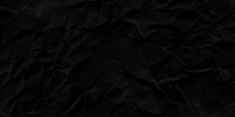 black paper background. Black dark crumpled roudh paper texture background.