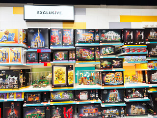 Fototapeta premium Exclusive colorful lego sets on display in a Manchester shop, bright shelves full of toys