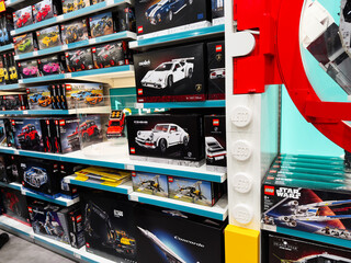 Obraz premium A wide LEGO display in a Manchester store featuring Technic and Star Wars sets on shelves