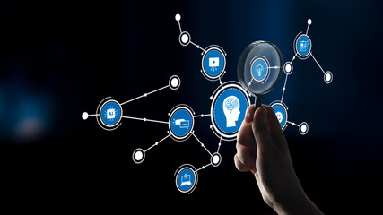 A hand holds a magnifying glass over an abstract digital network, symbolizing technology and data analysis in a modern business context. Explore the connections of innovation. Tessel