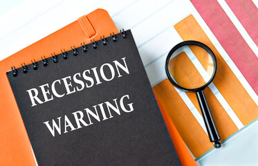 RECESSION WARNING - words on a black notepad on a chart background