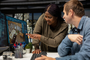 Graphic design team use architectural software and blueprints for 3D render of home interior. Program allows to configure furniture and other design elements for a virtual layout.