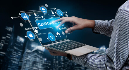 A person interacts with a modern laptop interface showcasing cloud computing features and data management, set against a vibrant city skyline at night. Tessel