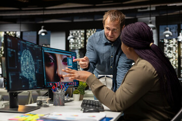 Multiethnic retouching team using neural networks for editing content, machine learning and editing new photo materials online. Professional designers using digital software and AI.