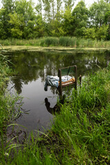 Abandoned floating chair in serene forest lake winter