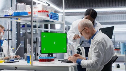 Isolated mockup on monitor next to diverse team in chemistry lab focuses on molecular science, conducting laboratory experiments in biotechnology and genetics research. Medical solutions.