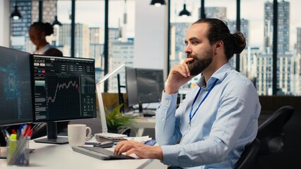 Portfolio manager in office using artificial intelligence to evaluate capital allocation based on...