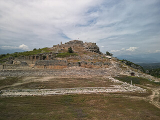 Aerial view of the acropolis and theater of ancient tlos above seydikemer Limestone terraces and ruins crown the hill Fethiye district mugla turkiye Wide valley and mountains beyond Lycian heritage