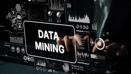 Hands Typing on Keyboard with Data Mining Graphics and Analytics Visuals Displayed on Screen in Dark Environment. Asymptotic smart data analytic.