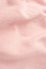 Soft pink cashmere sweater texture background.