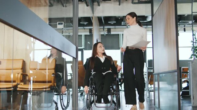 Team members discuss plans for a project in a modern coworking space focusing on inclusion and accessibility for all professionals