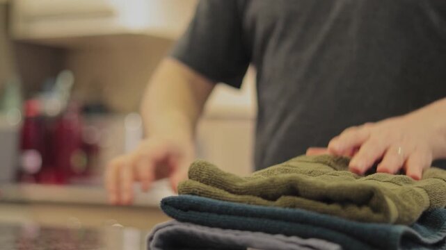 Close-Up of Folding Dish Towels in a Domestic Kitchen