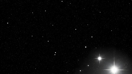 A black and white image of a starry night sky with bright celestial bodies shining