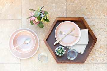 Aerial view of a decorated table with place settings and blooming flowers, ready for a meal