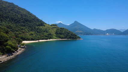 Obraz premium Aerial view of tropical beach and bay with boats and green hills