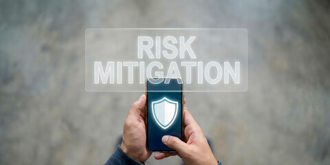 Business risk mitigation high level planning concept with mobile security shield icon and hand holding smartphone for cyber protection focus