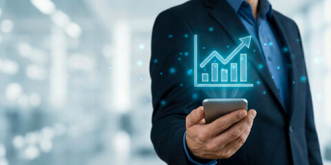 Business high level planning concept digital graph growth on mobile phone held by businessman in suit closeup focus on data hologram